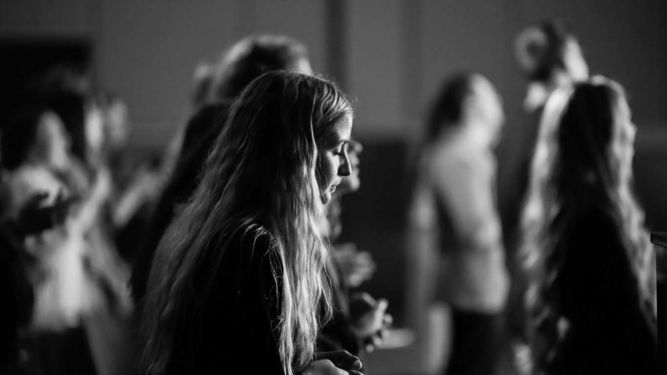 A woman worshipping in a gathering